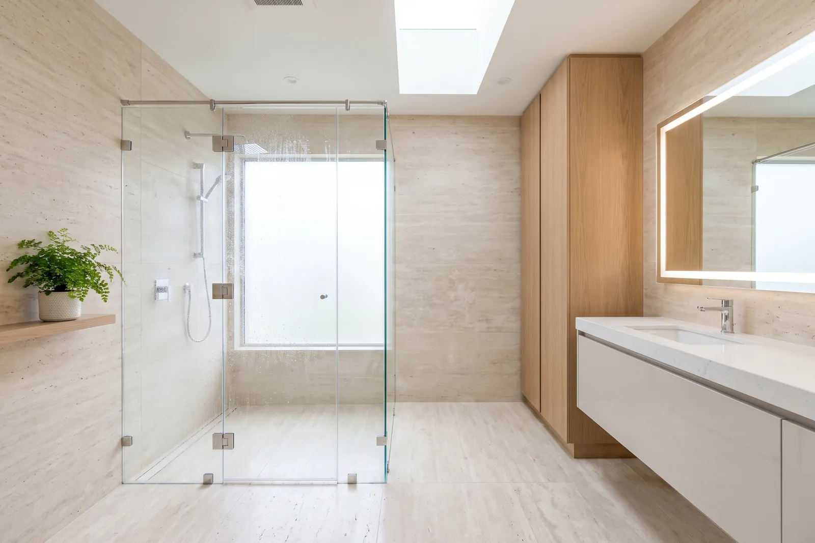 Rahmenlose Walk-in-Dusche aus klarem Sicherheitsglas in einem hellen Bad